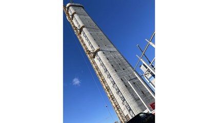 Concrete is poured into a mold that is slowly raised using hydraulic jacks. The tower has grown by 2.5 meters every day since work started in July 2024.